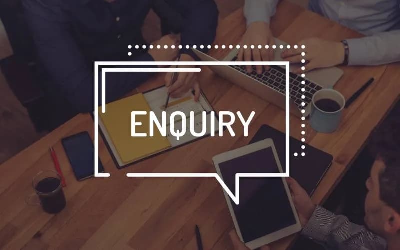 Business professionals collaborating around a table with an enquiry message graphic, representing customer support, questions, and communication.